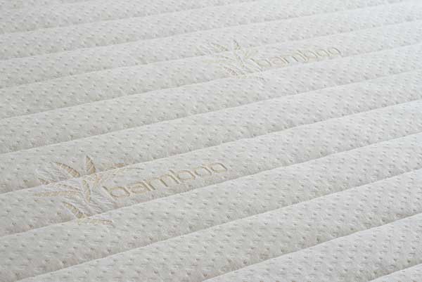 Close up photo of the Supernal Natural Bamboo Quilted Cover detailing its cream color,l quilted texture.