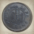 blackened bronze coin has a stylized vulture and the inscription, "Crom Counts the Dead" in Icelandic Elder Futhark runes