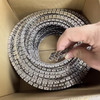 Bendable metal track coiled up in box