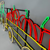 LED neon pumpkin tractor with colorful wheels and pumpkin-filled trailer, designed as a festive Halloween decoration.