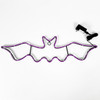 Purple lighted bat sign with white background