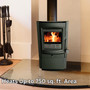 lifestyle image of comfort glow mighty mini wood stove with fire burning noting it heats up to 750 square feet area