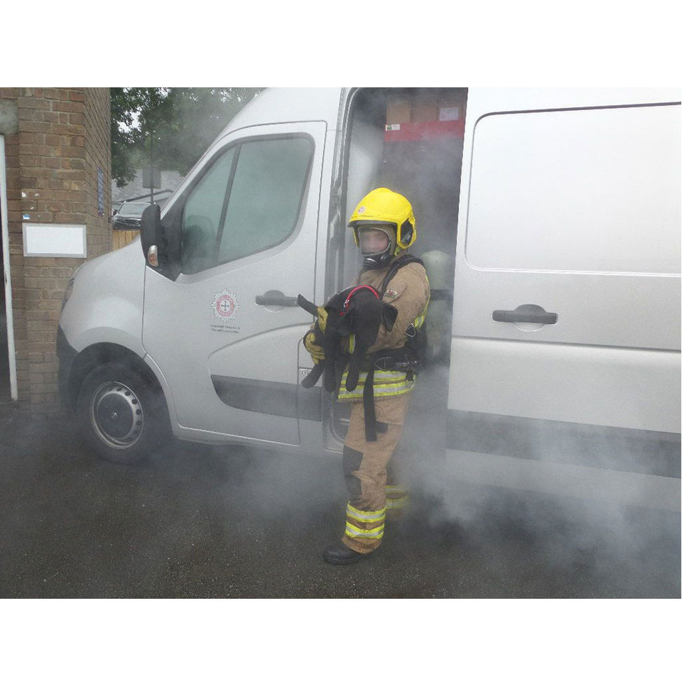 a black ruth lee dog/canine manikin being rescued from a smoke filled van