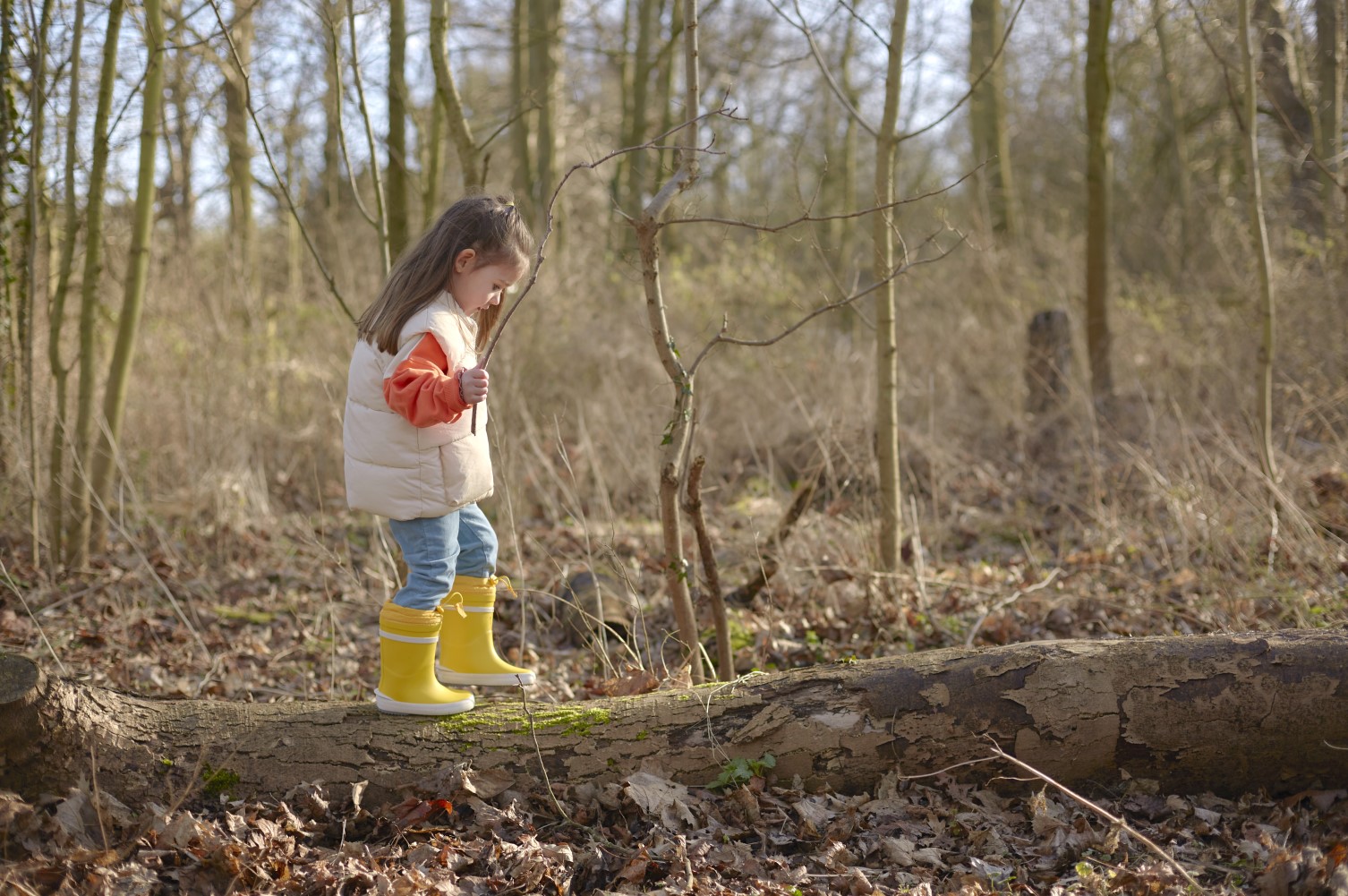 Girl in wellies on a woodland walk