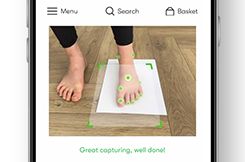 Image of SizeWise scan in progress with side image of child's foot on an A4 piece of paper.