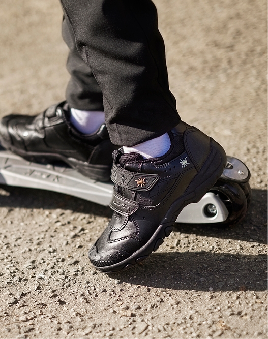 Boy in Start-Rite Shoes on a skateboard