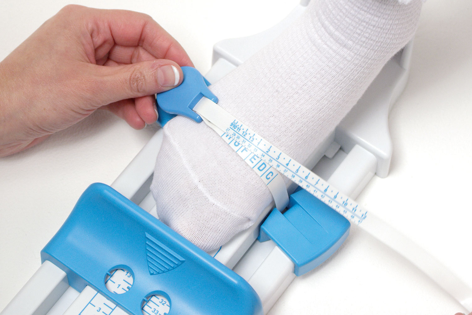 A child having their foot measured using a professional fitter’s measuring gauge