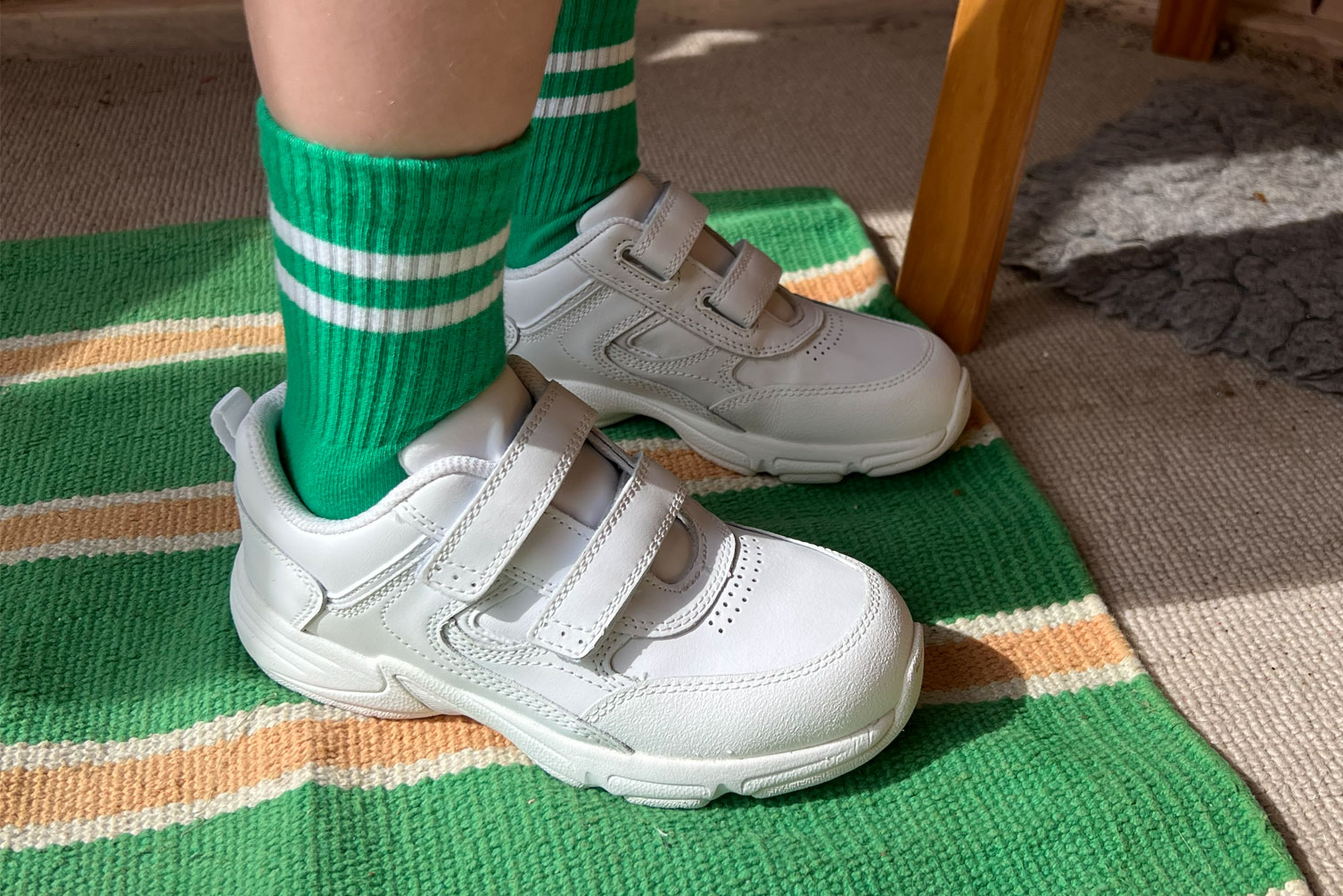 Girl wearing Start-Rite white trainers