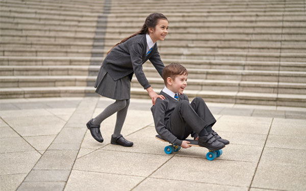 Boy and Girl Playing on Skateboard Boy and Girl Playing on Skateboard