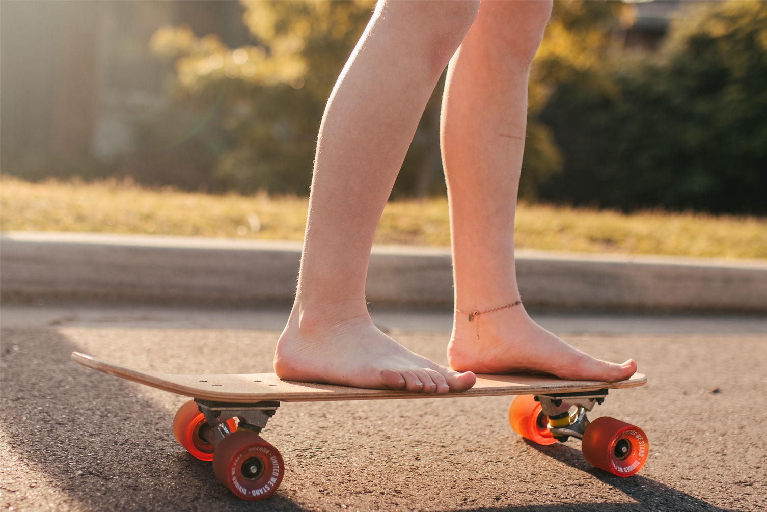 Girl with bare feet on a skateboard