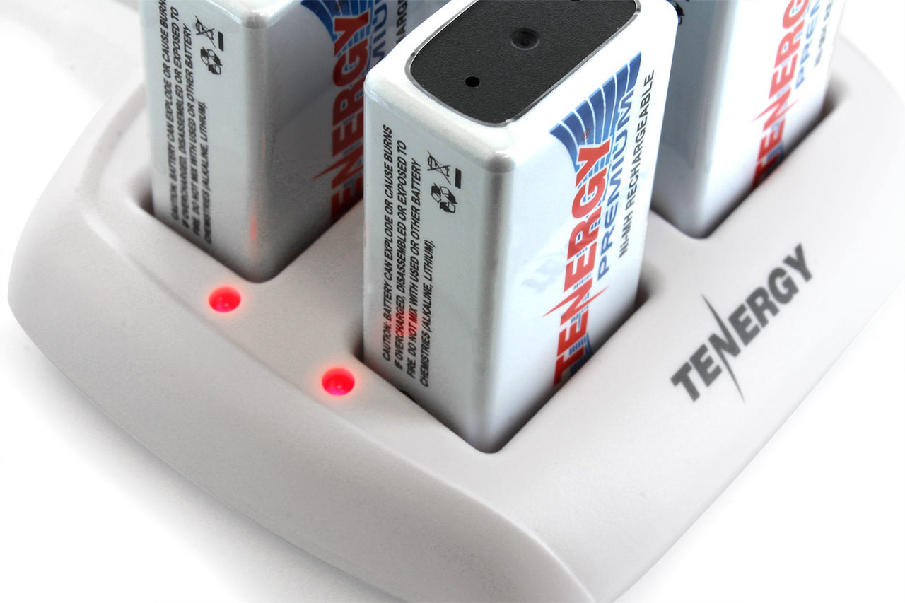 Red LED indicators on this multi-slot battery charger signal the active charging status of individual power cells.
