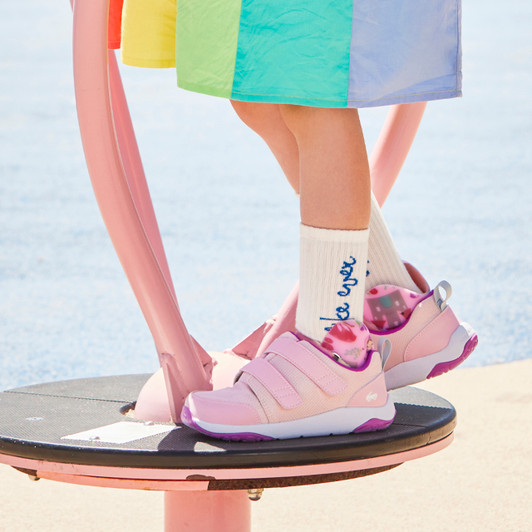 Child on a playground, wearing the Ryder Adapt II Pink sneakers Child on a playground, wearing the Ryder Adapt II Pink sneakers