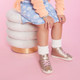 Girl wearing Hudson Gold sneakers
