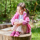 Lifestyle photo of a girl wearing the Camp Slipper Berry