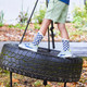 Child on a tire swing, wearing Riley Gray sneakers