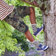 Boy climbing a tree, wearing the Stevie II Navy Denim