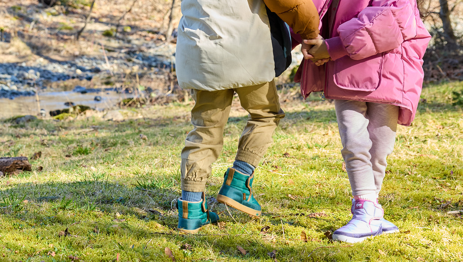 Two boy and one girl toddlers wearing First Walker styles from the Fall/Winter 2025 Collection.
