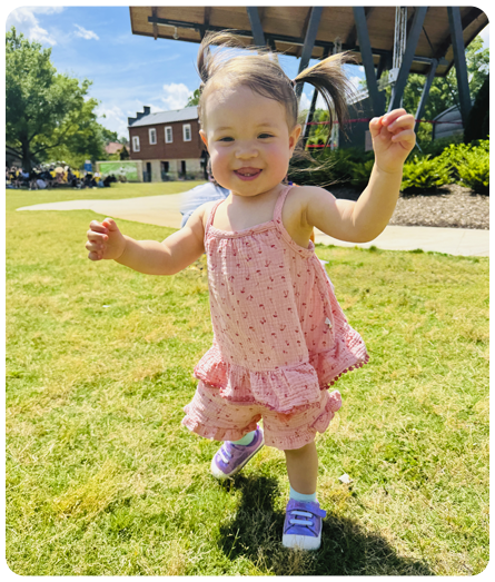Girl wearing Stevie Mini first walker sneakers