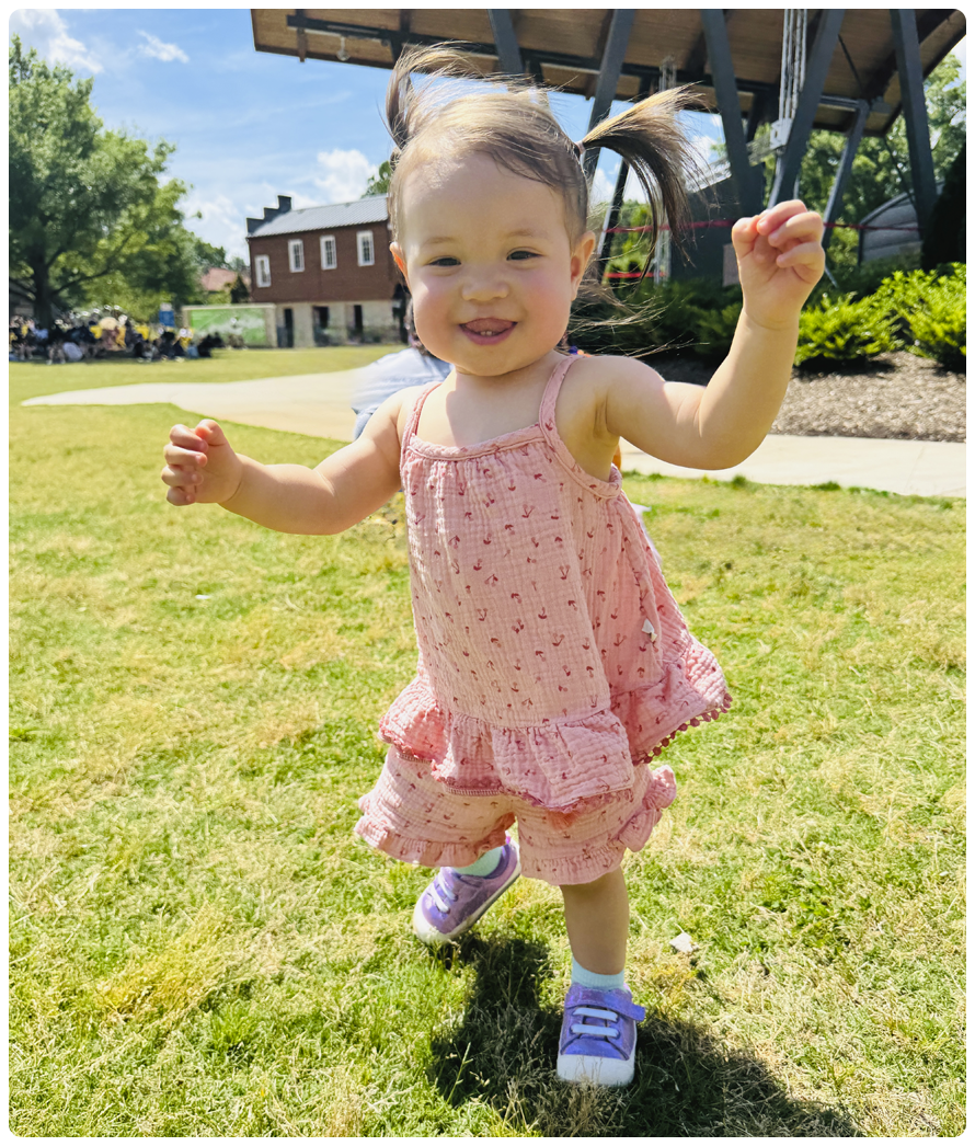 Girl wearing Stevie Mini first walker sneakers