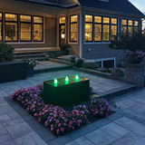 Triple Cuboid Fountain by night lit with green plumes
