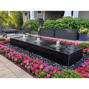 96-inch Acrylic Heiho low-profile triple-plume fountain in a landscaped patio setting