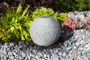 Large Ribbed Sphere Gray Granite Fountain Kit in garden setting