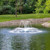 Airmax SolarSeries crown and arch nozzle pond spray pattern view on a SolarSeries Solar Fountain