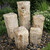 Five-column yellow onyx fountain kit with illuminated bubbling water feature in landscaped garden