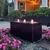 Triple Cuboid Fountain by night lit with pink plumes