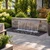 Blue Thumb Large Formal Falls 40-inch stainless steel waterfall installed in a stacked stone retaining wall with cascading water, black river pebbles, and landscaped backyard patio. --AI