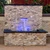 Blue Thumb Small Formal Falls Light Kit installed in a stone retaining wall with a 16-inch sheet waterfall illuminated by purple LED lighting.