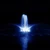 A vibrant blue fountain illuminates the dark night, with water arcs gracefully reaching outwards. The scene conveys peace and beauty.