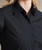 Close-up of button placket and collar detail on Premier PR309 women’s supreme poplin short sleeve shirt in black – embroidered corporate shirt