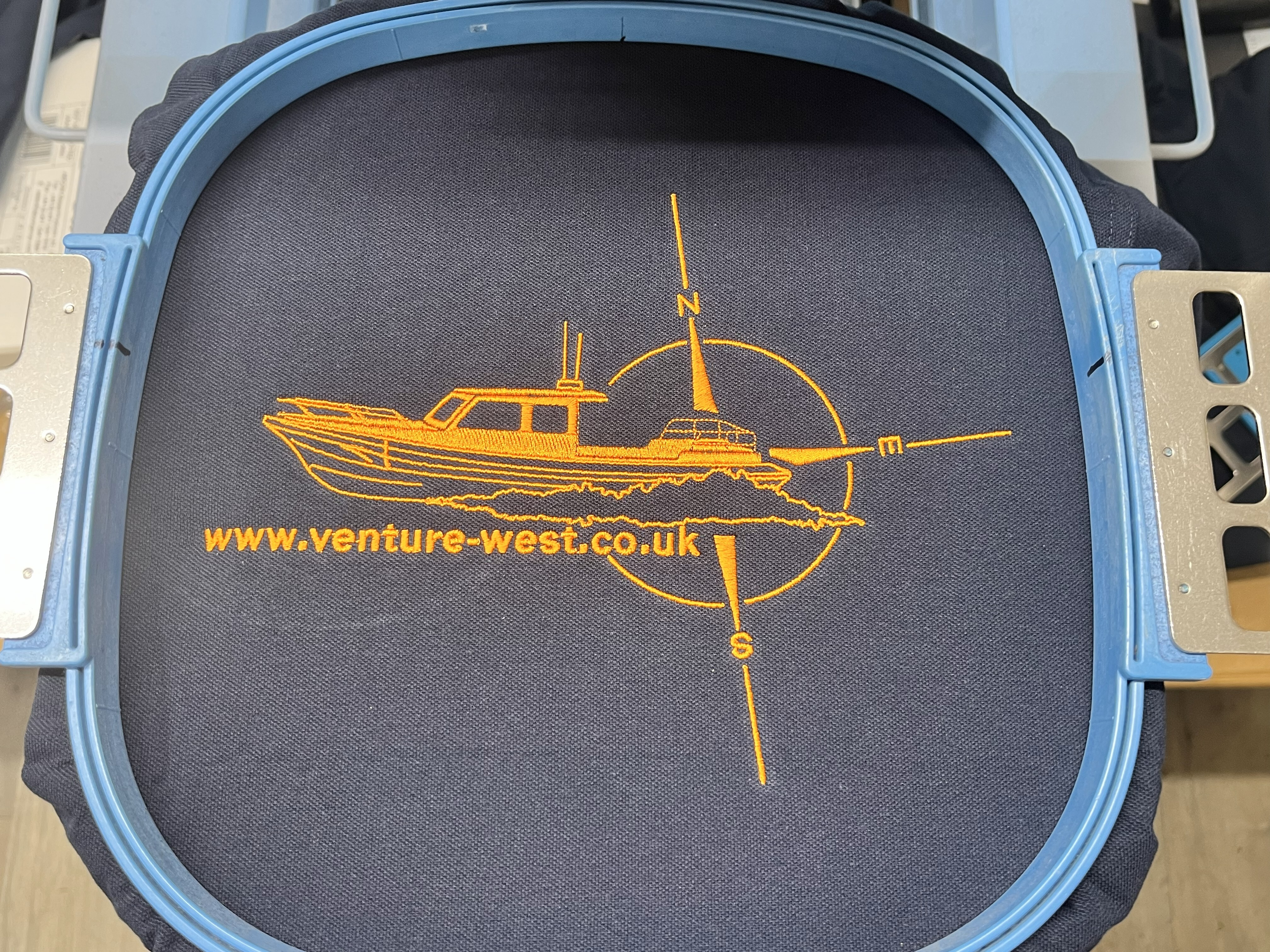 Close-up of logo embroidery on workwear garment