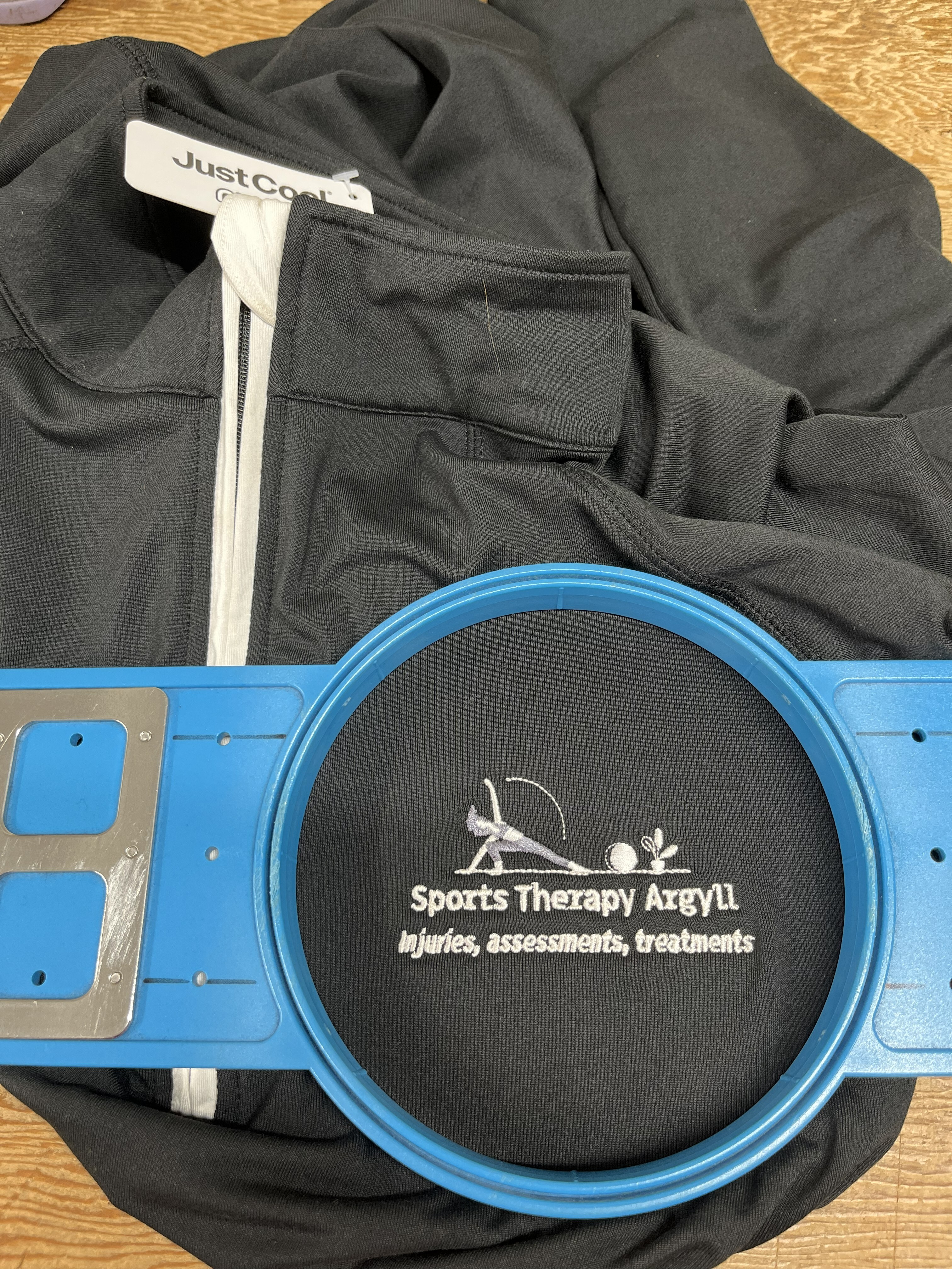 Left breast embroidered logo on a Black Sports Top