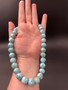 Larimar Necklace being hold in a hand