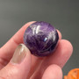 Miniature Brazilian Amethyst Sphere in a hand