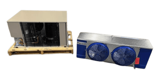 Beige condensing unit on a wooden pallet alongside a dual-fan evaporator unit