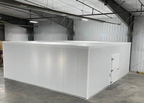 Large white drive-in cooler with sliding door and insulated panel walls