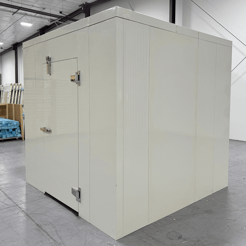 White walk-in cooler unit with closed hinged door and insulated panel walls front left view