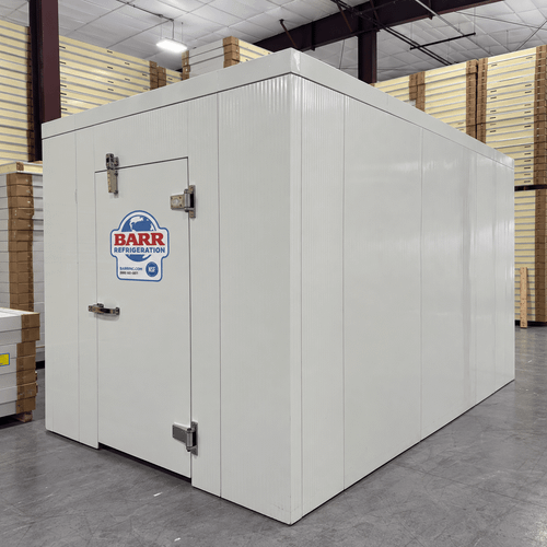 White walk-in cooler unit with open hinged door, featuring insulated panel walls