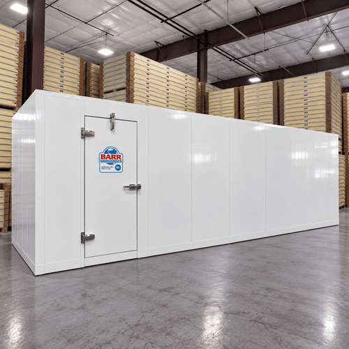 White walk-in cooler unit with closed hinged door, featuring insulated panel walls  front right view