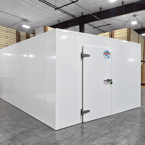 White walk-in cooler unit with closed hinged door, featuring insulated panel walls