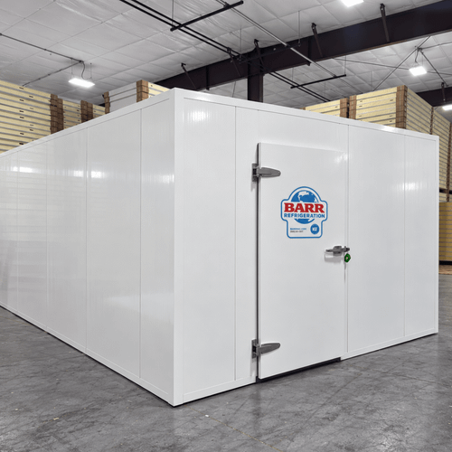 White walk-in cooler unit with closed hinged door, featuring insulated panel walls