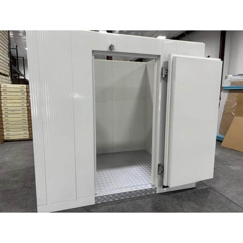 White walk-in commercial freezer with an open door revealing a textured floor