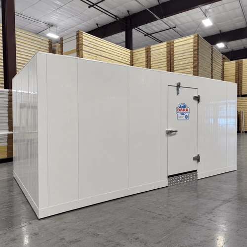 White walk-in freezer unit with floor, closed hinged door, and insulated panel walls