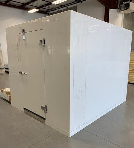 White walk-in commercial freezer with closed door