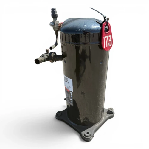 Front view of a used Copeland ZF15K4E-TF5 5.5 HP compressor, a tall black scroll-style shell with a red inventory tag "173" hanging from a cable tie near the top cap, service valve with black cap on top, and a four-bolt gray mounting base.