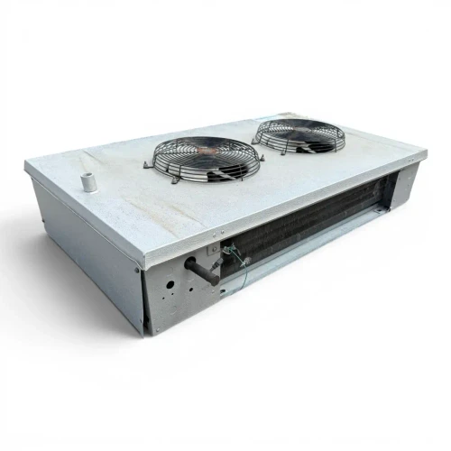 Front-left view of a used Hussmann GAL24-90E low velocity evaporator #1033, a white fan coil unit with two round black-grille fans and Hussmann label.