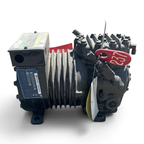 Front-left view of the used Copeland KALA-015A-TAC 1.5 HP compressor, showing the rating plate ("Copeland Copelametic"), the red "237" tag and yellow tag at the valve assembly, and the finned motor housing.
